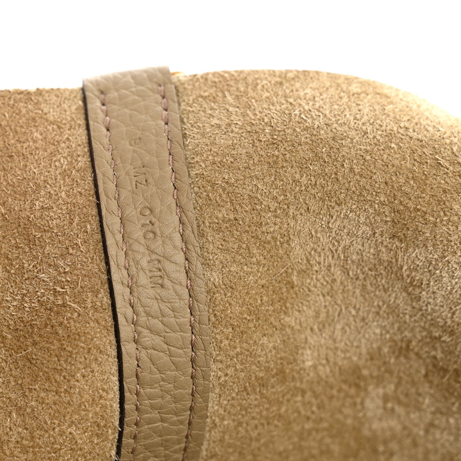 Beige suede lining panel with stitched leather edge