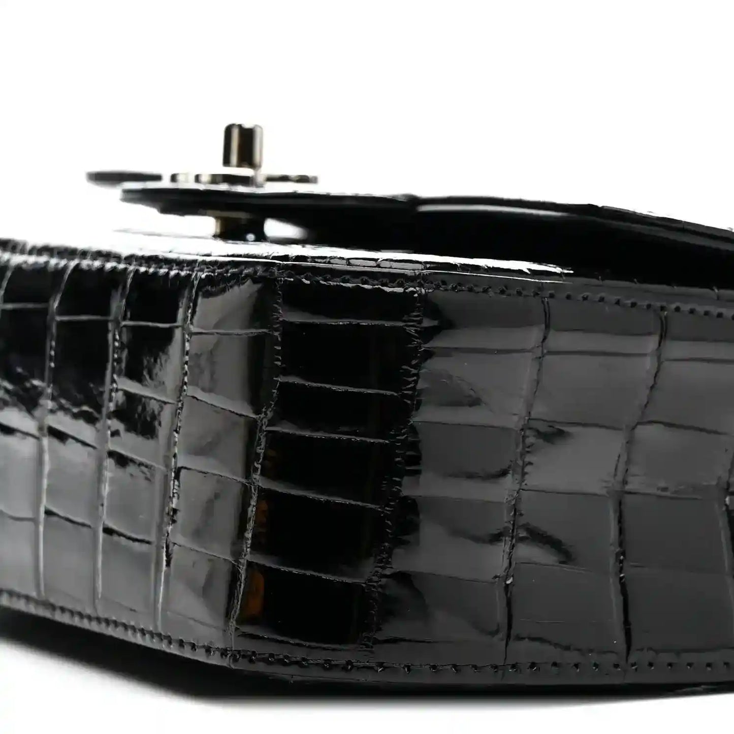 Black shiny alligator side panel with top hardware and chain strap ring.