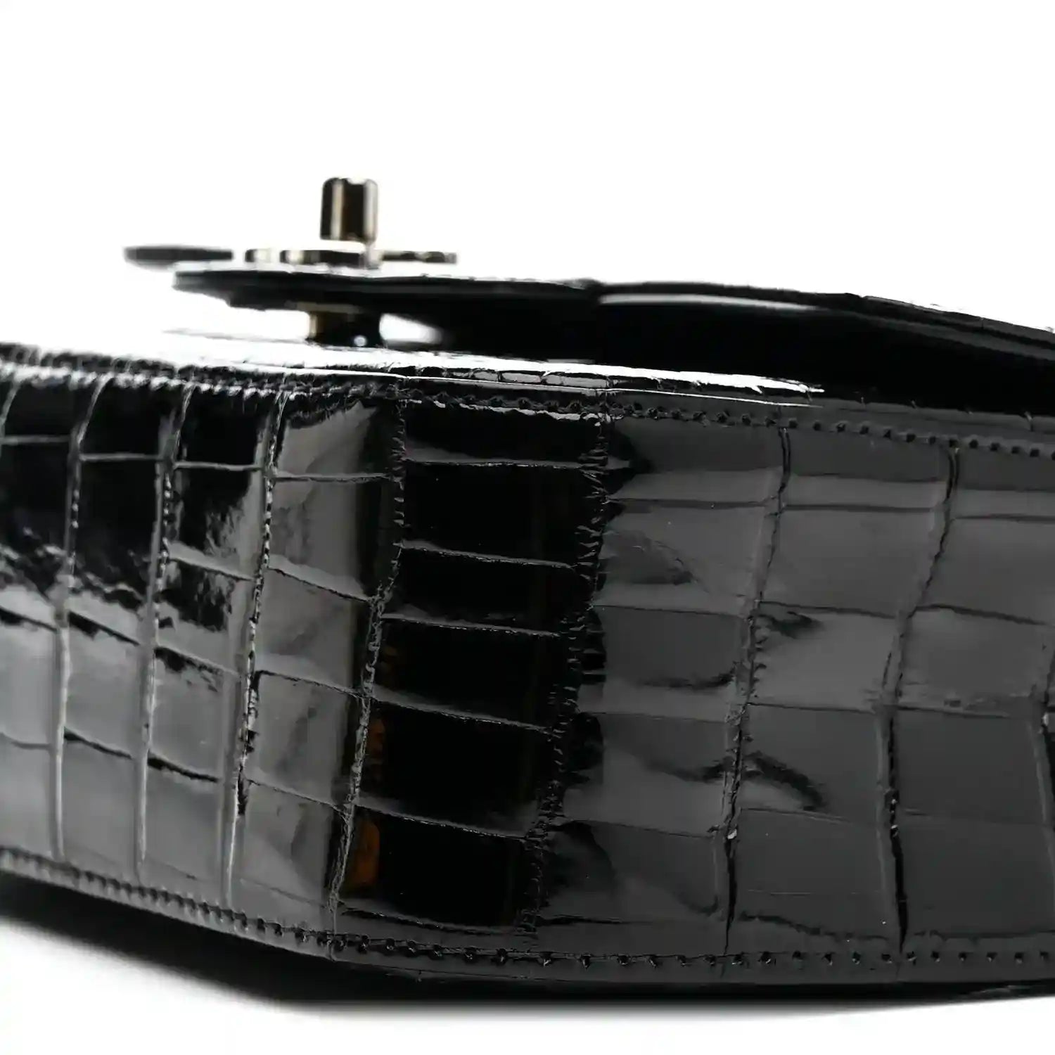 Black shiny alligator side panel with top hardware and chain strap ring.