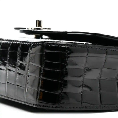 Black shiny alligator side panel with top hardware and chain strap ring.