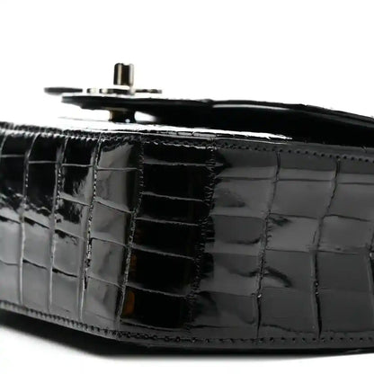 Black shiny alligator side panel with top hardware and chain strap ring.