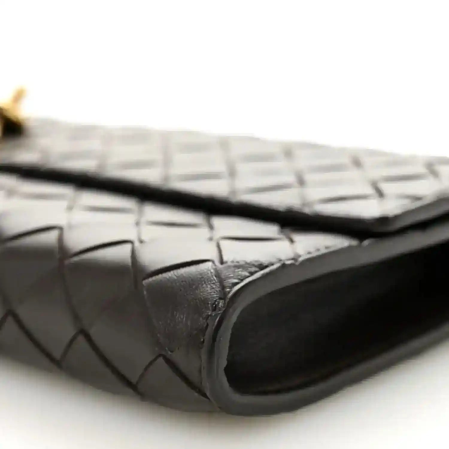 Black intrecciato clutch corner with smooth leather trim and stitched edge