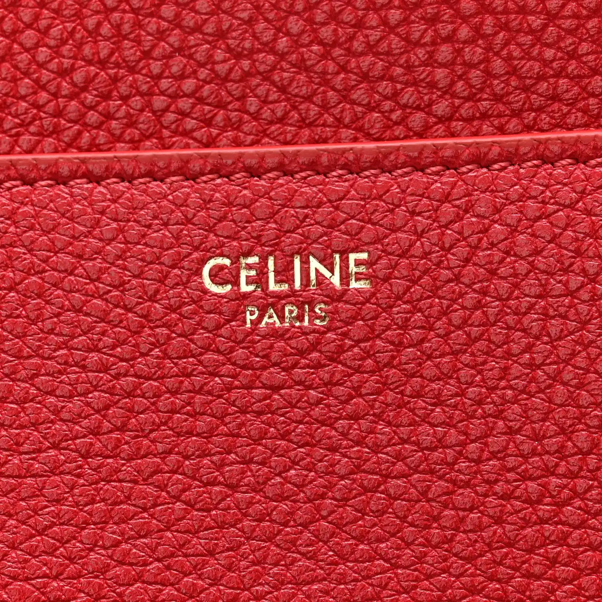 Red grained leather panel with CELINE PARIS logo embossing