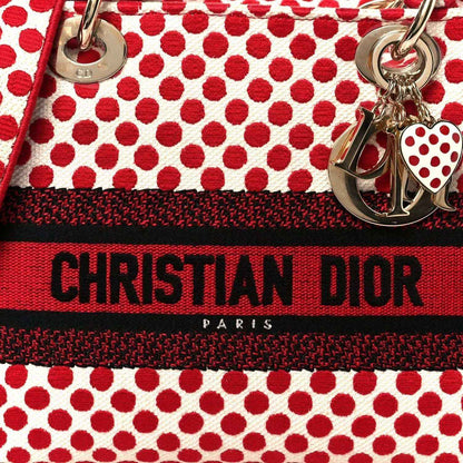 Red and black striped band on polka dot canvas bag with Christian Dior Paris text