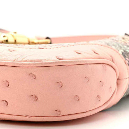 Gucci small hobo bag close-up of pale pink ostrich-style leather and gold clasp