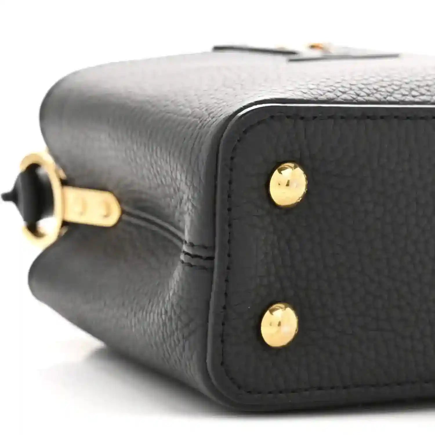 Black textured leather mini bag side with gold-tone studs and top handle hardware