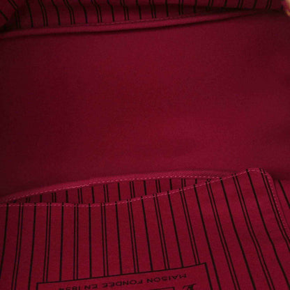 Tote bag interior lining in deep burgundy with stitched edge seam