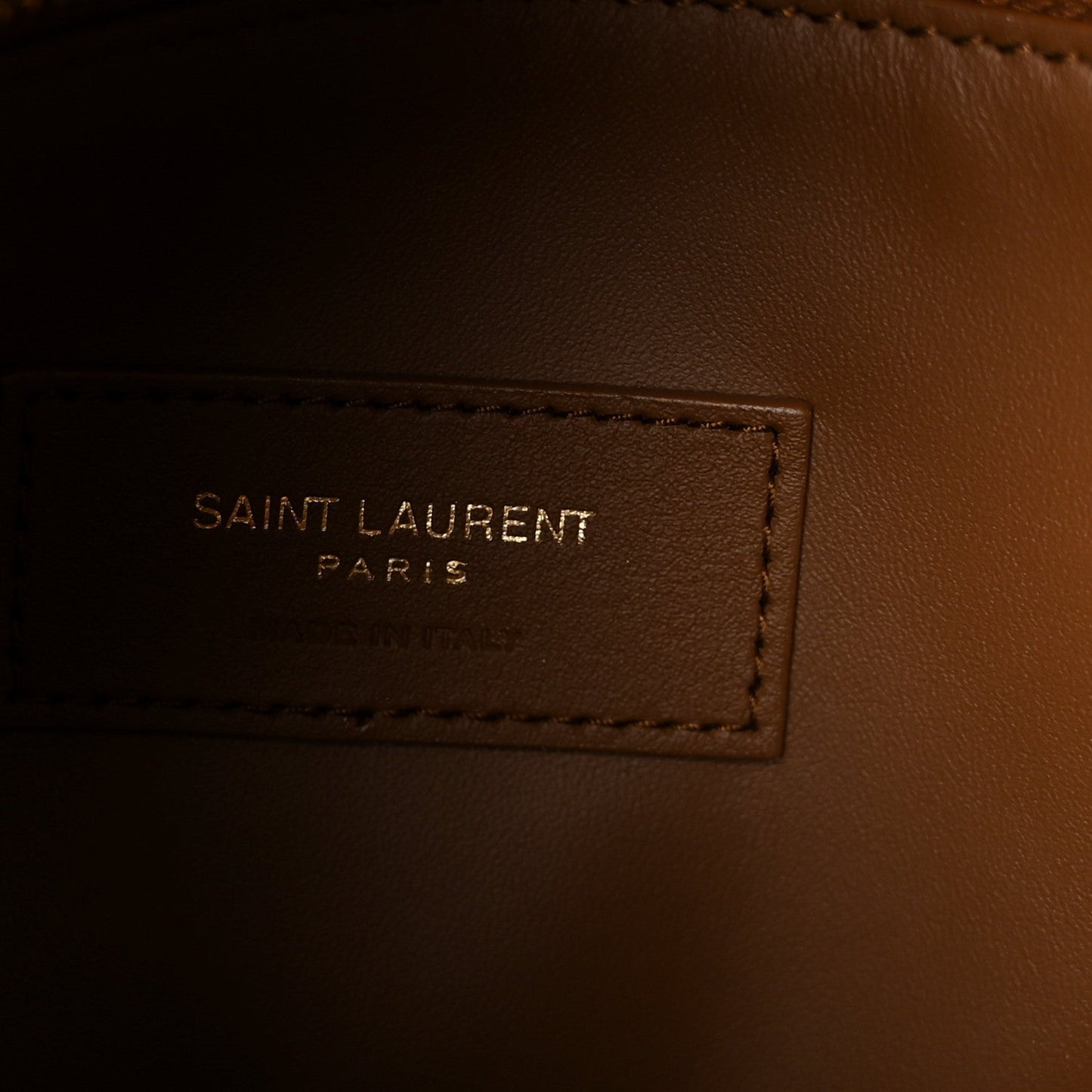 Saint Laurent hobo bag interior label reading "SAINT LAURENT PARIS" on brown lining