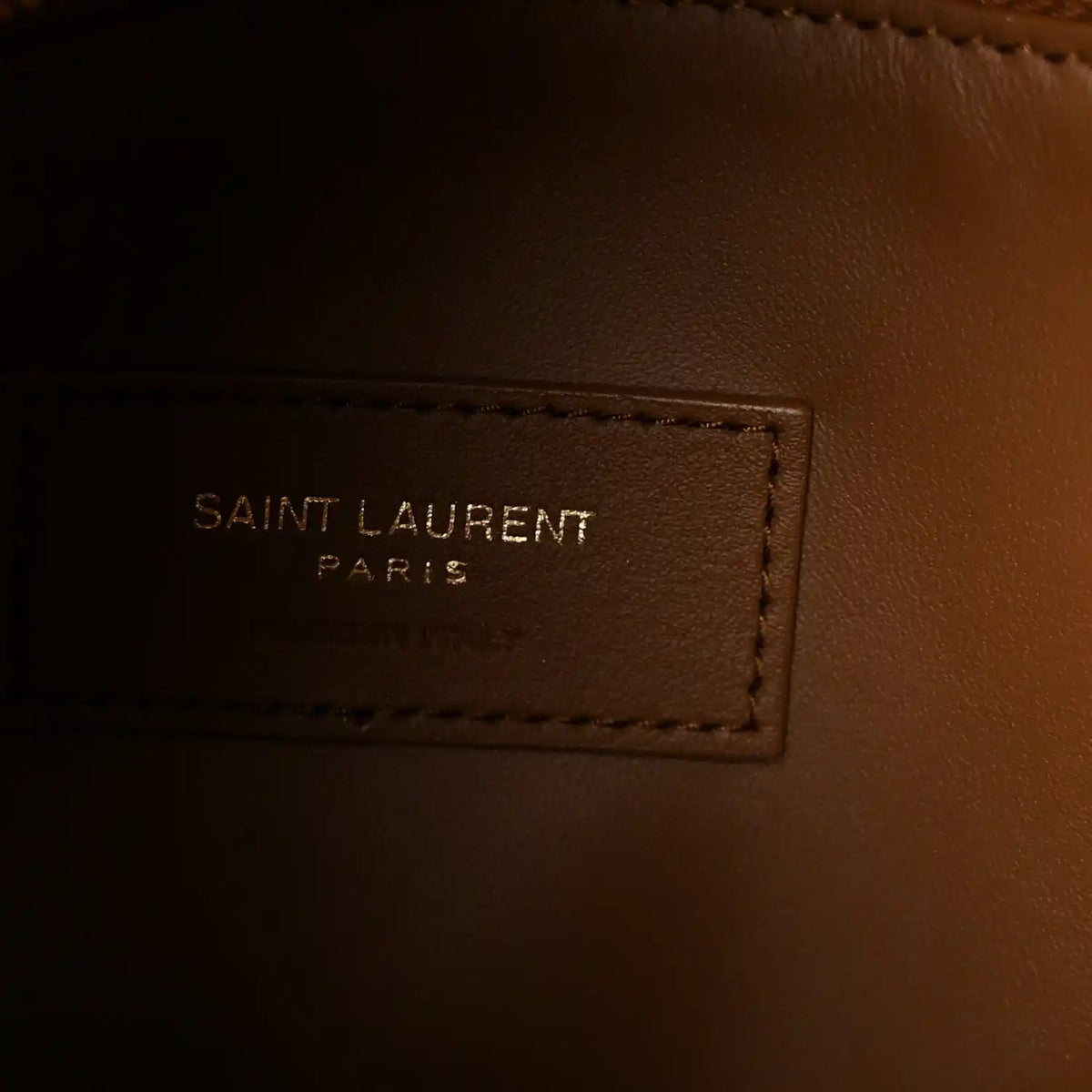 Saint Laurent hobo bag interior label reading "SAINT LAURENT PARIS" on brown lining