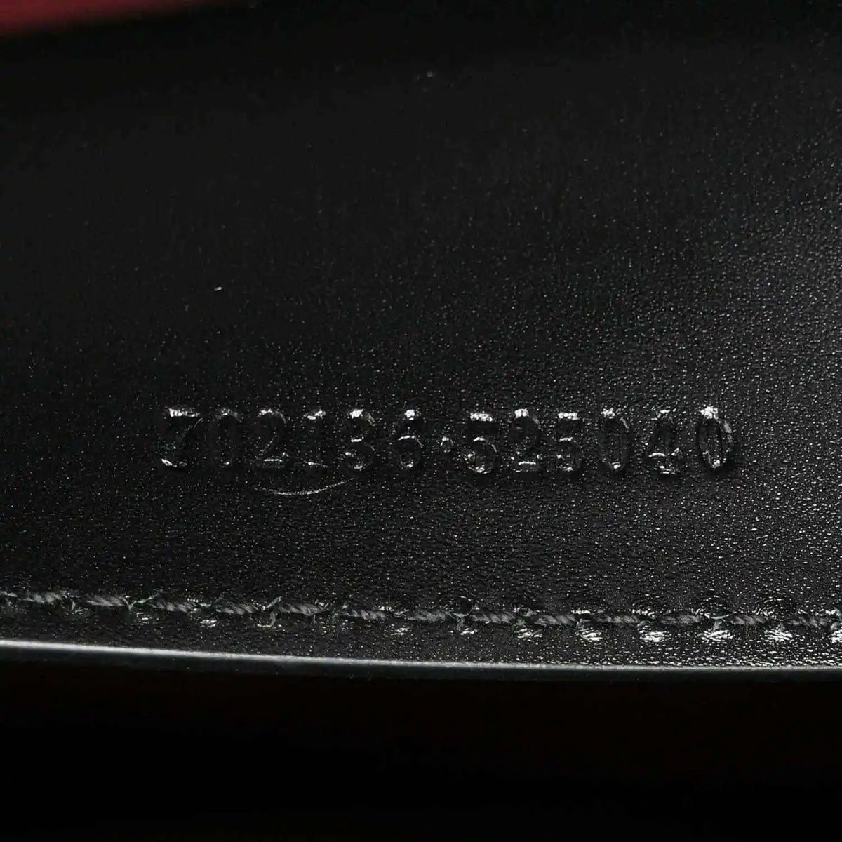 Black leather base stamp reading 3123555140 and Made in Italy