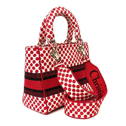 Red and white polka dot canvas tote bag with crossbody strap and heart charm