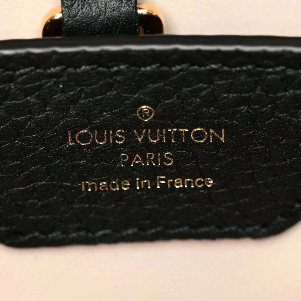 Black leather handbag brand patch with gold Louis Vuitton Paris text