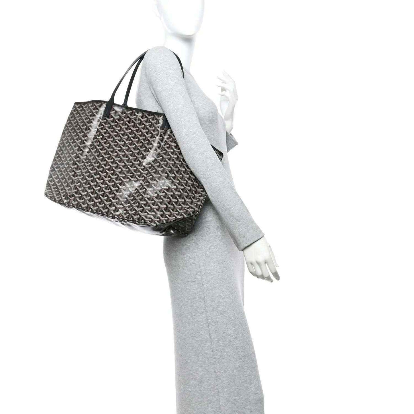Goyardine tote bag with Goyardine monogram pattern and black handles, worn on mannequin