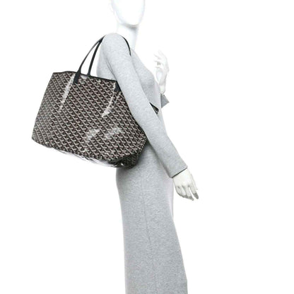 Goyardine tote bag with Goyardine monogram pattern and black handles, worn on mannequin