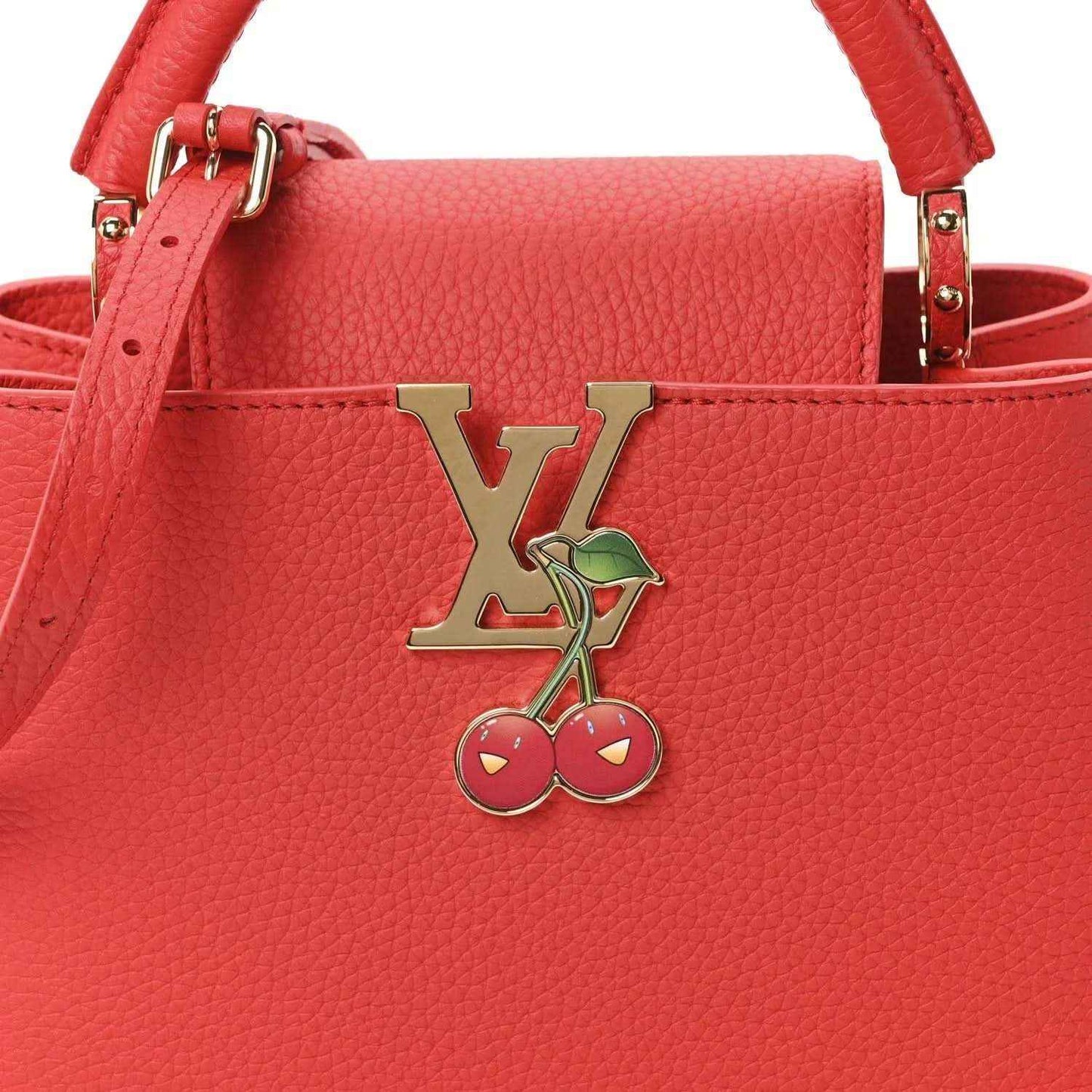 Red leather mini handbag front with LV cherry charm and gold-tone clasp hardware.