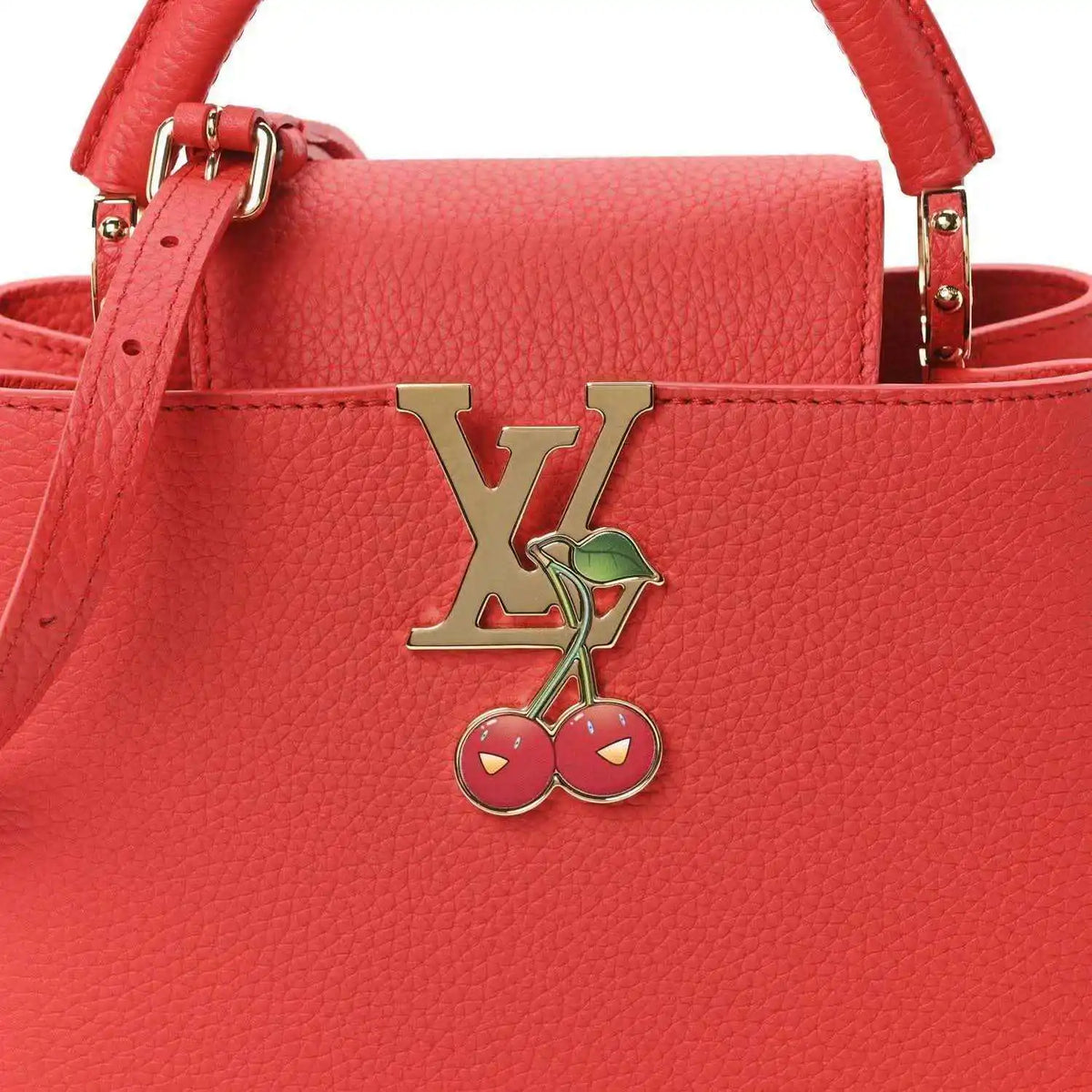 Red leather mini handbag front with LV cherry charm and gold-tone clasp hardware.