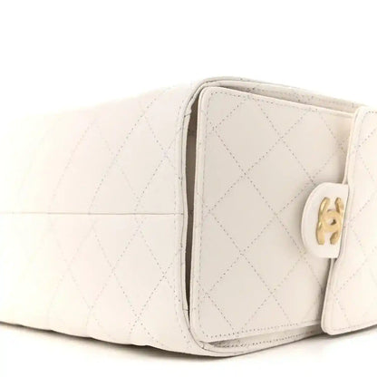 White quilted caviar leather handbag with gold-tone clasp and side profile