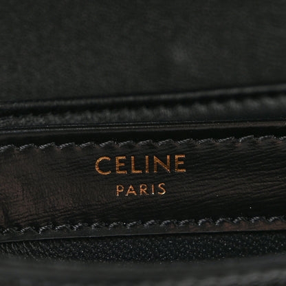 Black leather mini crossbody bag with gold-tone “CELINE PARIS” logo stamp