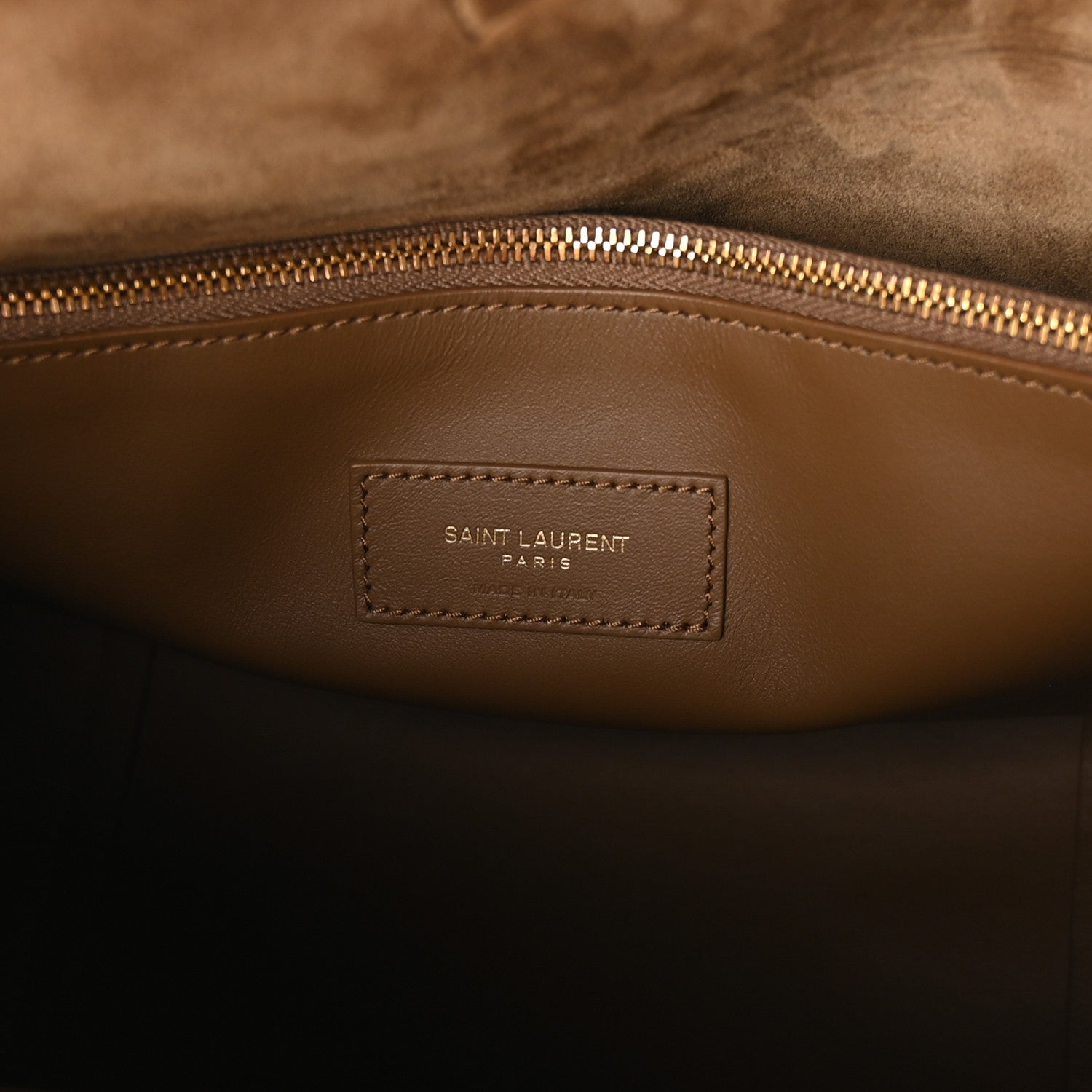 Suede hobo bag interior with stitched Saint Laurent Paris label and gold zipper