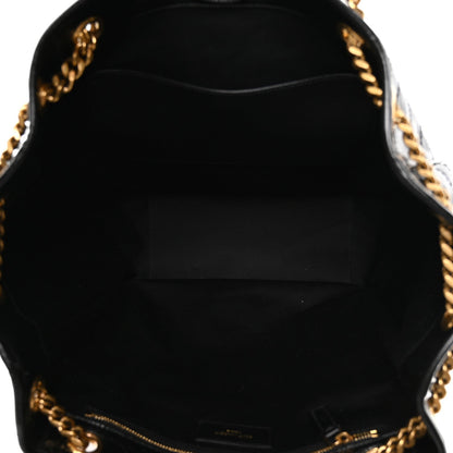 Black fabric-lined tote interior with gold zipper track and chain edge