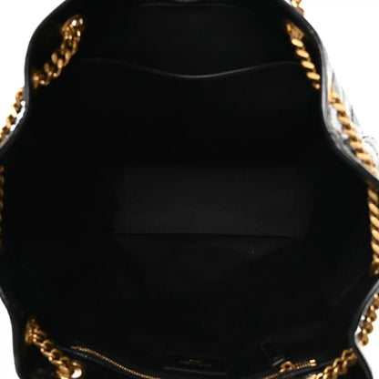 Black fabric-lined tote interior with gold zipper track and chain edge