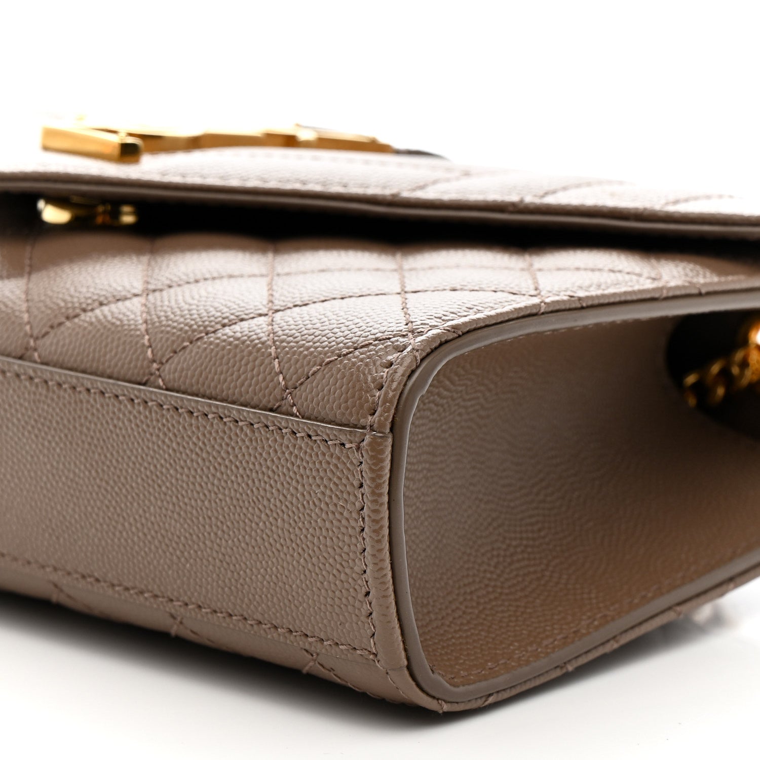 Dark beige quilted satchel side with stitched trim and curved leather edge
