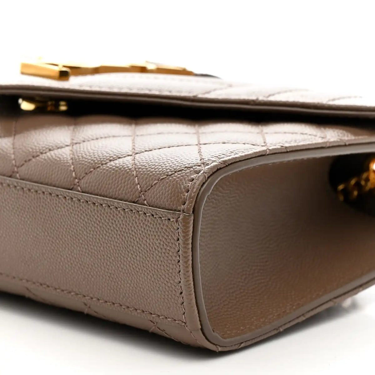 Dark beige quilted satchel side with stitched trim and curved leather edge