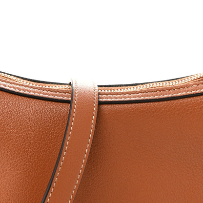 Tan leather bag top with stitched handle attachment and matching crossbody strap