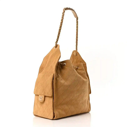 Chanel suede quilted medium handbag in classic beige with front flap pocket and chain strap