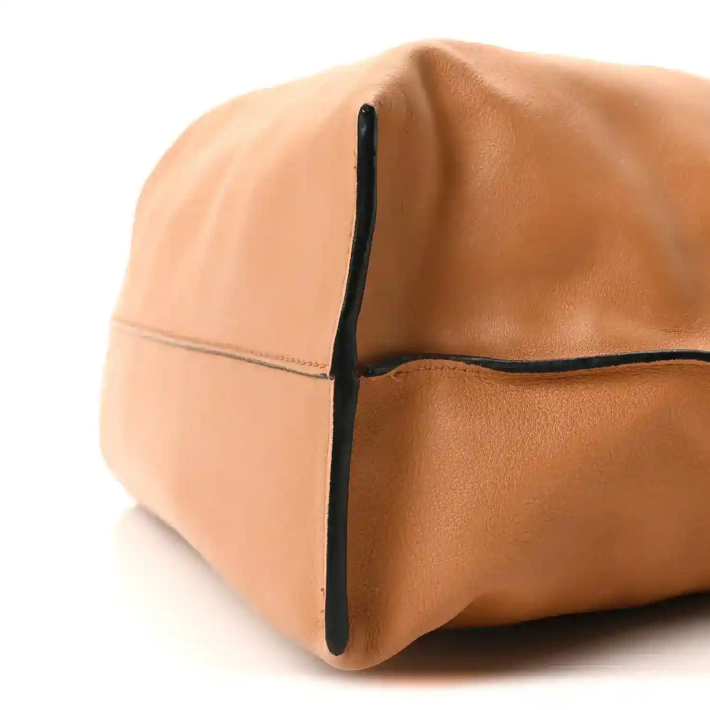 Loewe Flamenco knot bag side panel close-up, warm tan leather and dark edge trim.