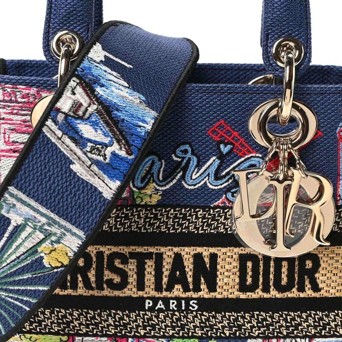 Blue embroidered handbag front with gold Dior emblem charm and Paris lettering