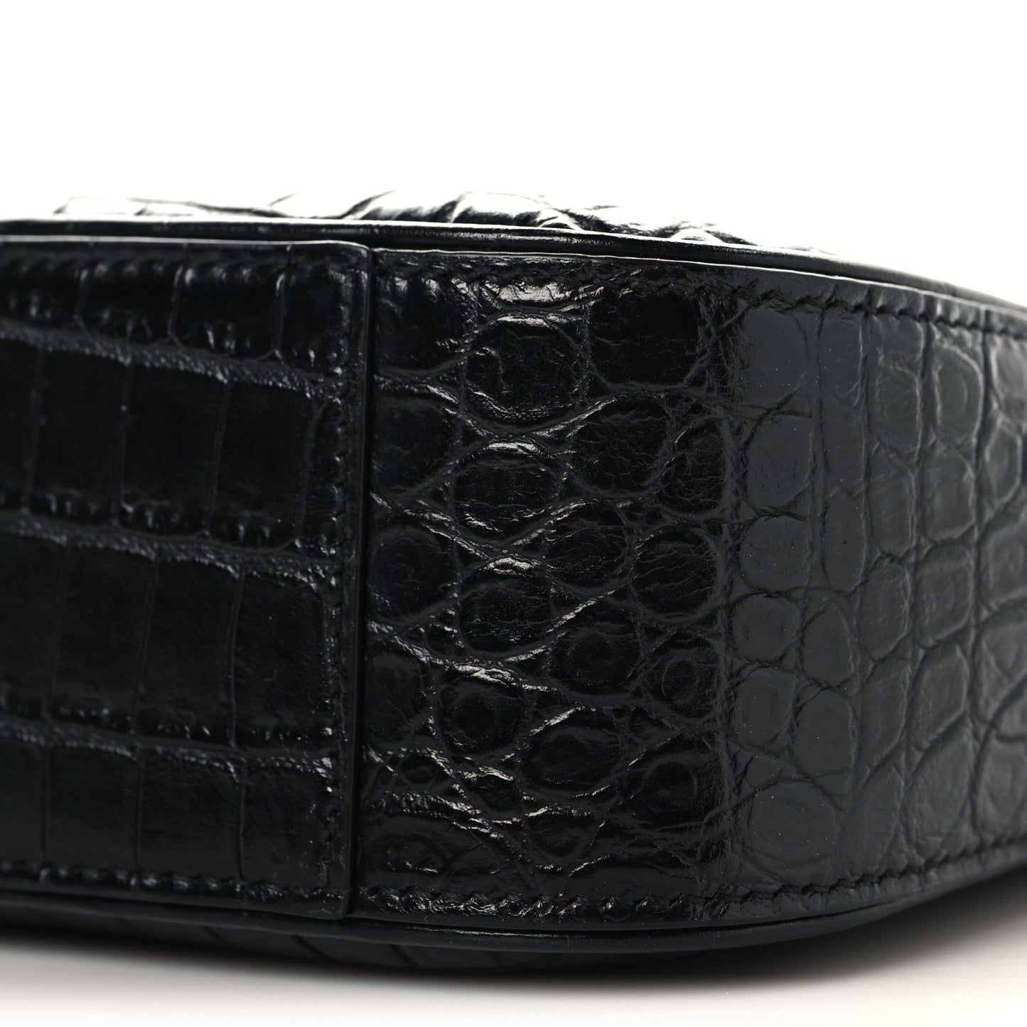 Black crocodile-embossed hobo shoulder bag corner panel close-up with stitching