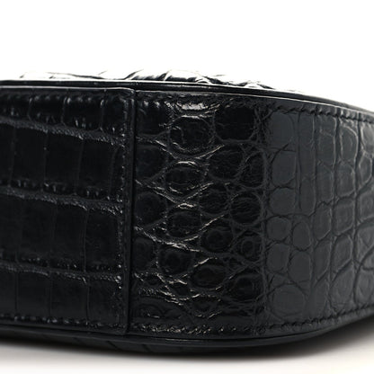 Black crocodile-embossed hobo shoulder bag corner panel close-up with stitching