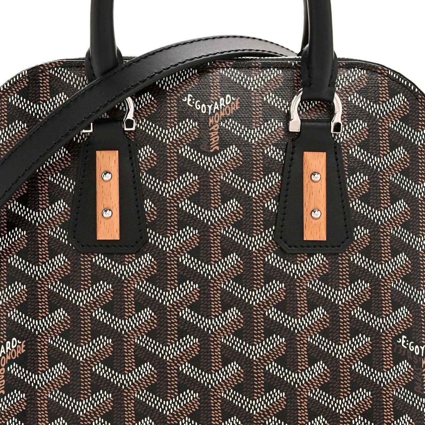 Mini handbag front detail: monogram canvas, black straps with tan leather tabs