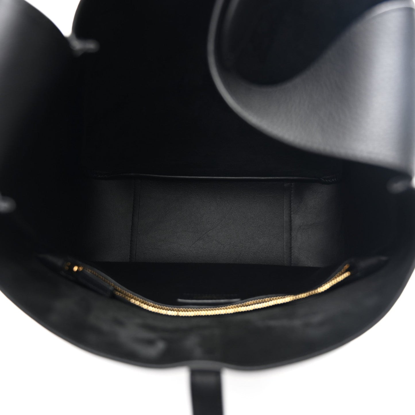 Black leather hobo bag interior view with gold chain edging along the opening