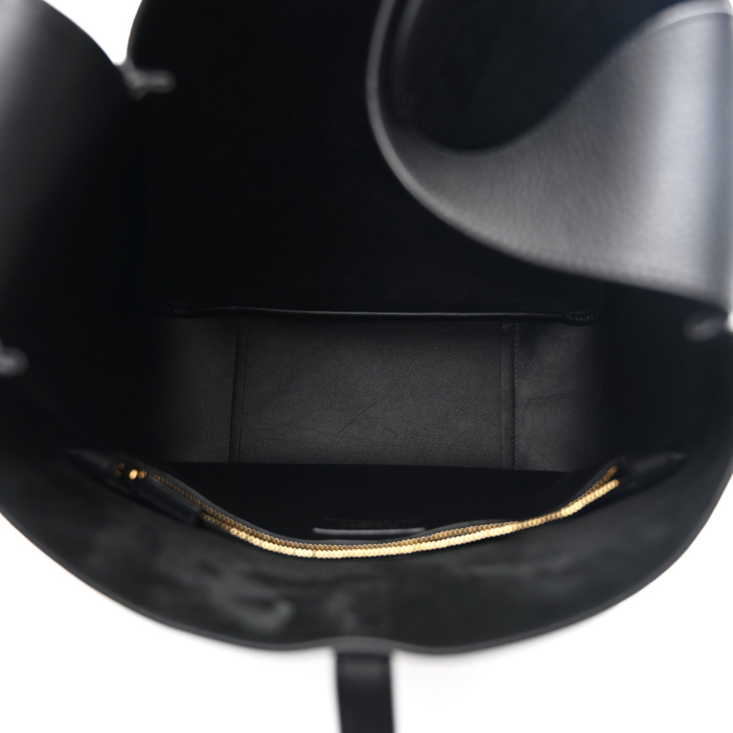 Black leather hobo bag interior view with gold chain edging along the opening