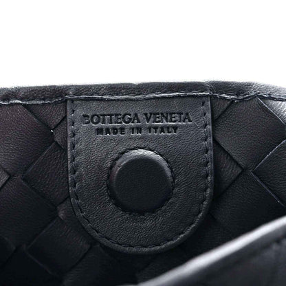 Close-up of black leather bag patch with Bottega Veneta branding and Italy text