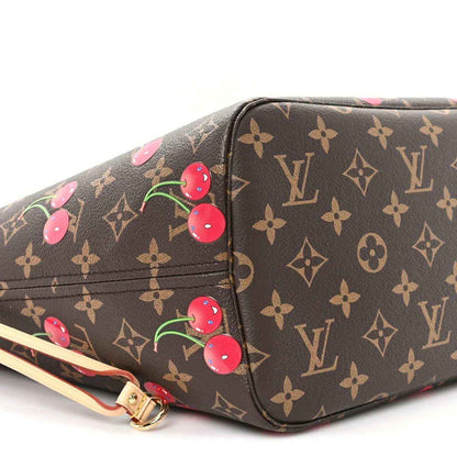 Monogram tote bag corner with cherry motif and strap attachment hardware.