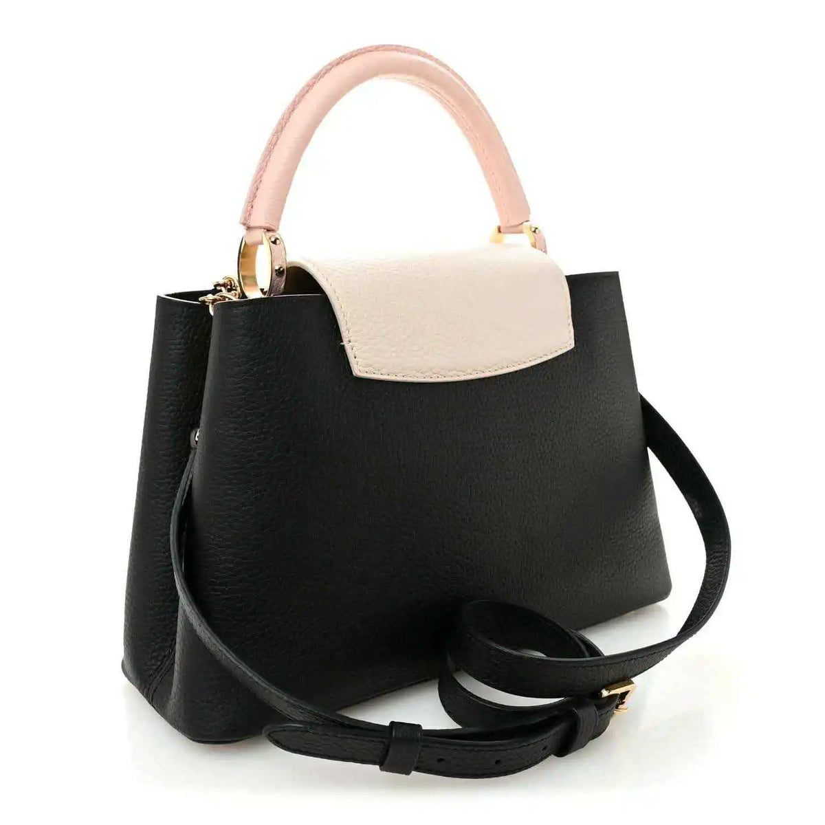 Black leather handbag with light cream top panel, pink handle, and black shoulder strap
