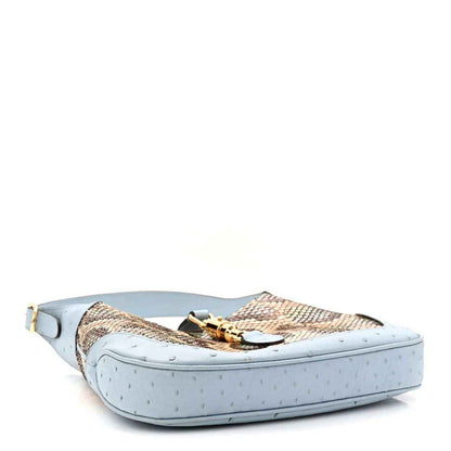 Small hobo bag side view with snakeskin body and light blue leather base