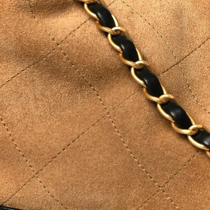 Beige suede panel with quilted stitching and black-and-gold chain strap