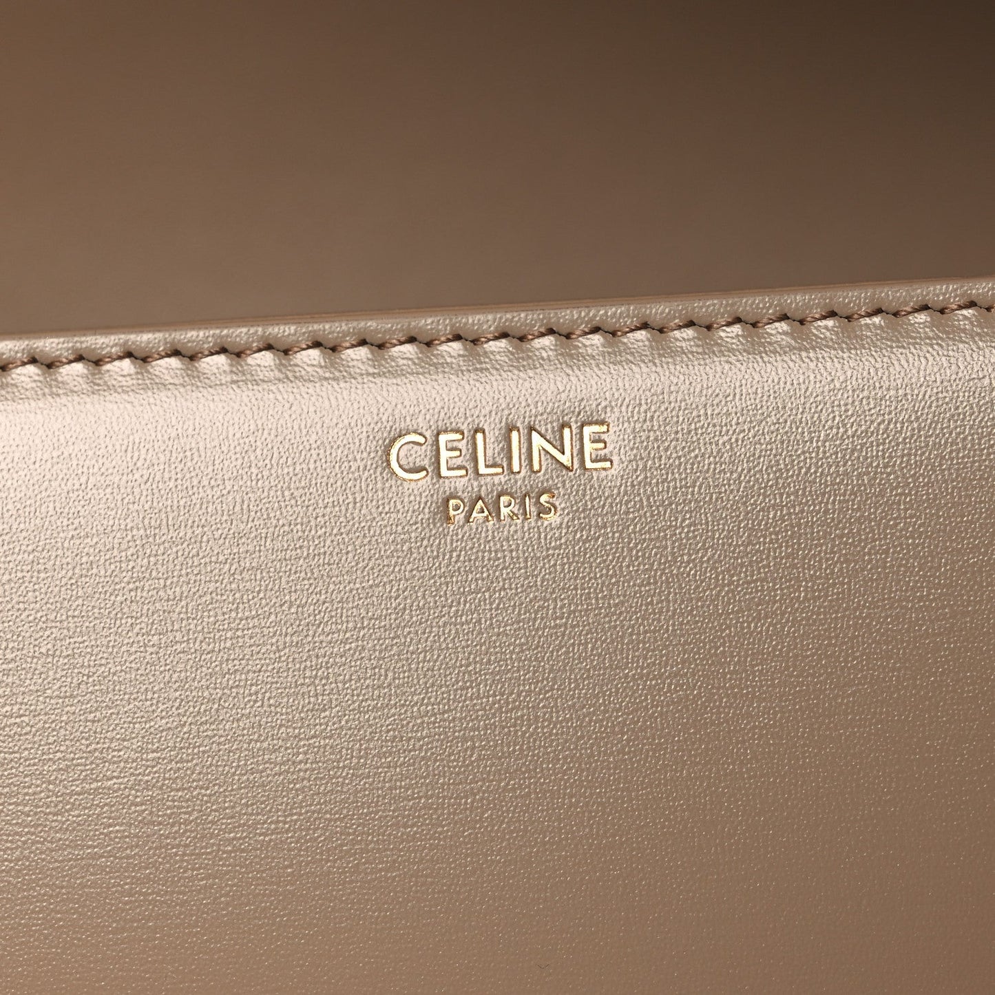 Celine Paris embossed on beige leather with visible edge stitching