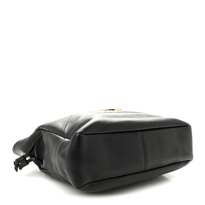 Black lambskin tote with rounded base and braided drawstring bow at side.
