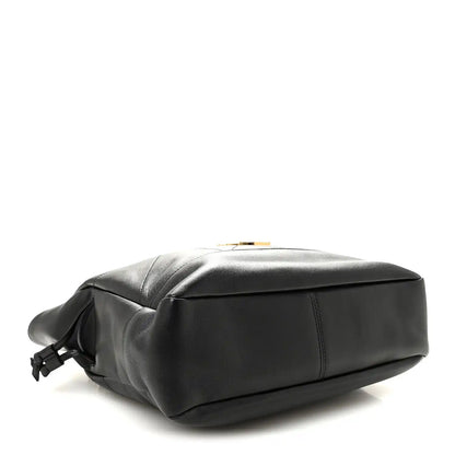 Black lambskin tote with rounded base and braided drawstring bow at side.
