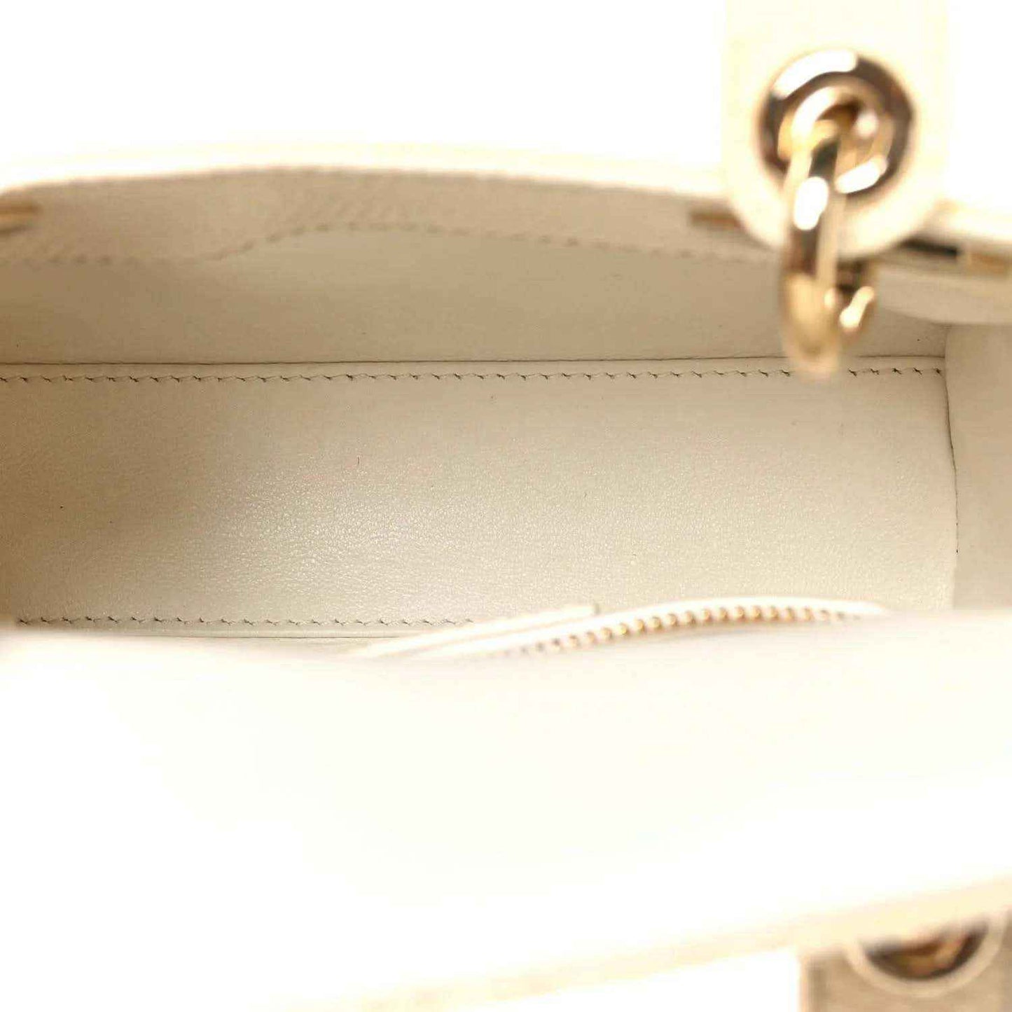 Ivory mini handbag interior with zipper edge and gold ring hardware