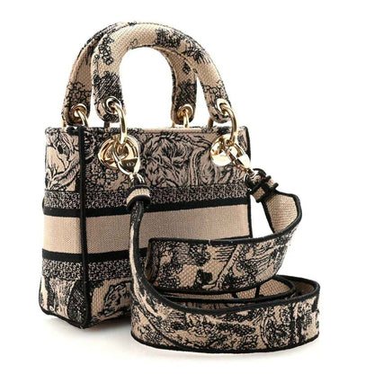 Mini embroidered handbag with top handles, adjustable crossbody strap, and gold hardware