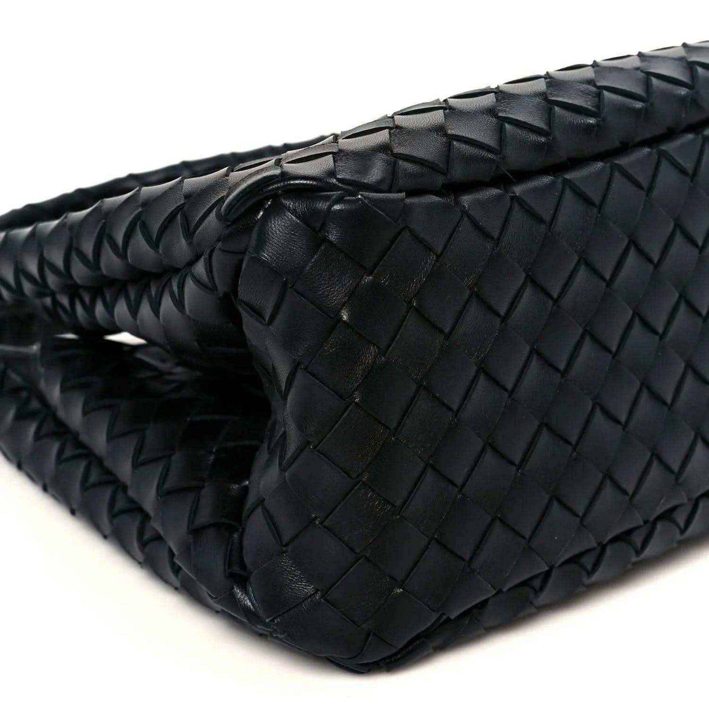 Black intrecciato leather bag close-up of top edge and woven basket texture