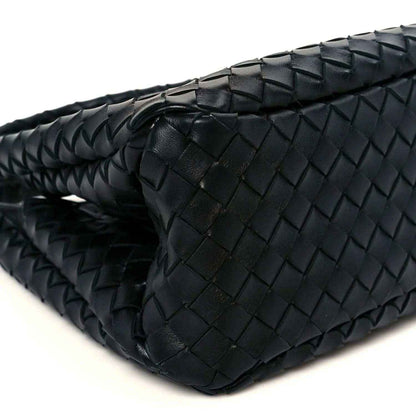 Black intrecciato leather bag close-up of top edge and woven basket texture