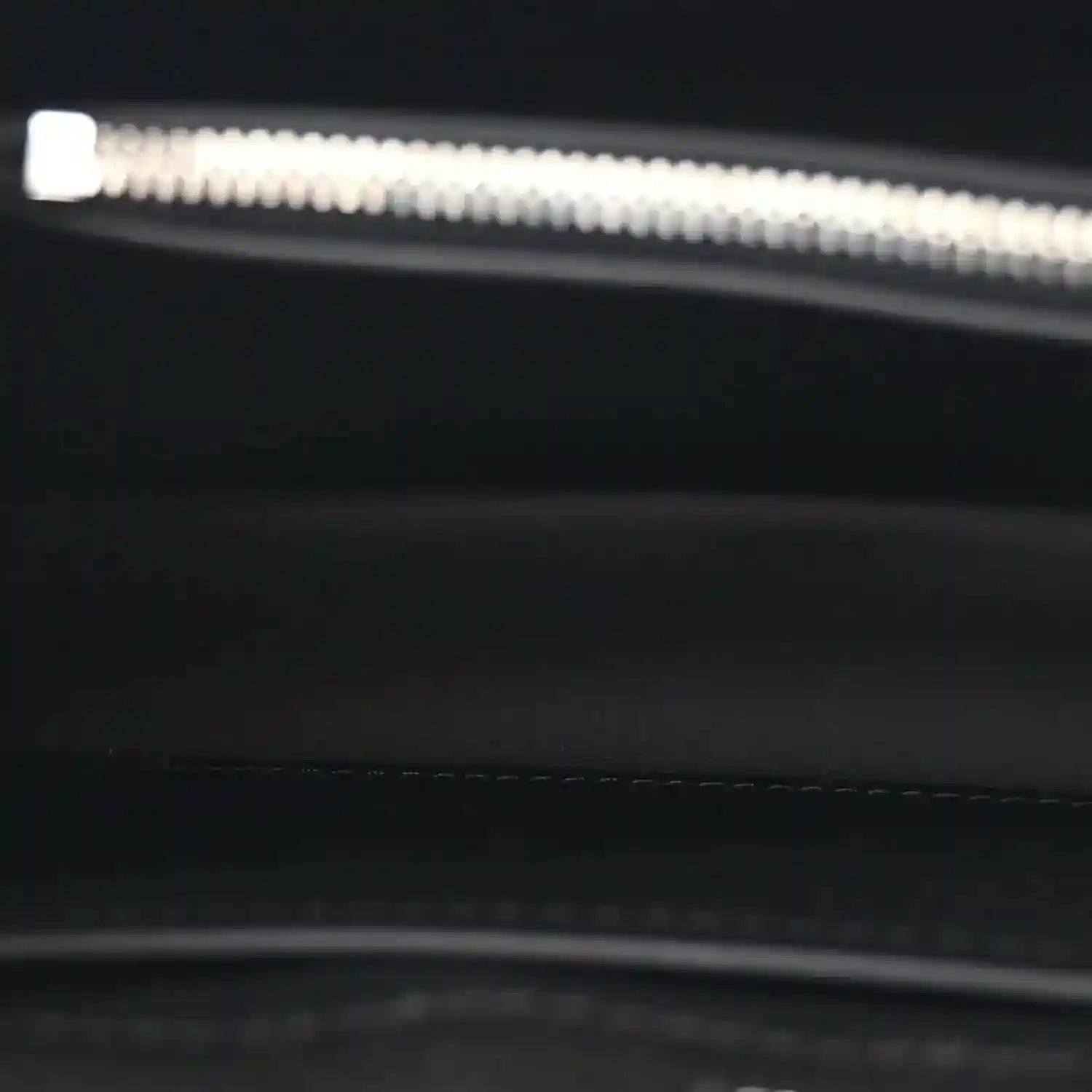 Black leather handbag interior zipper edge with silver hardware