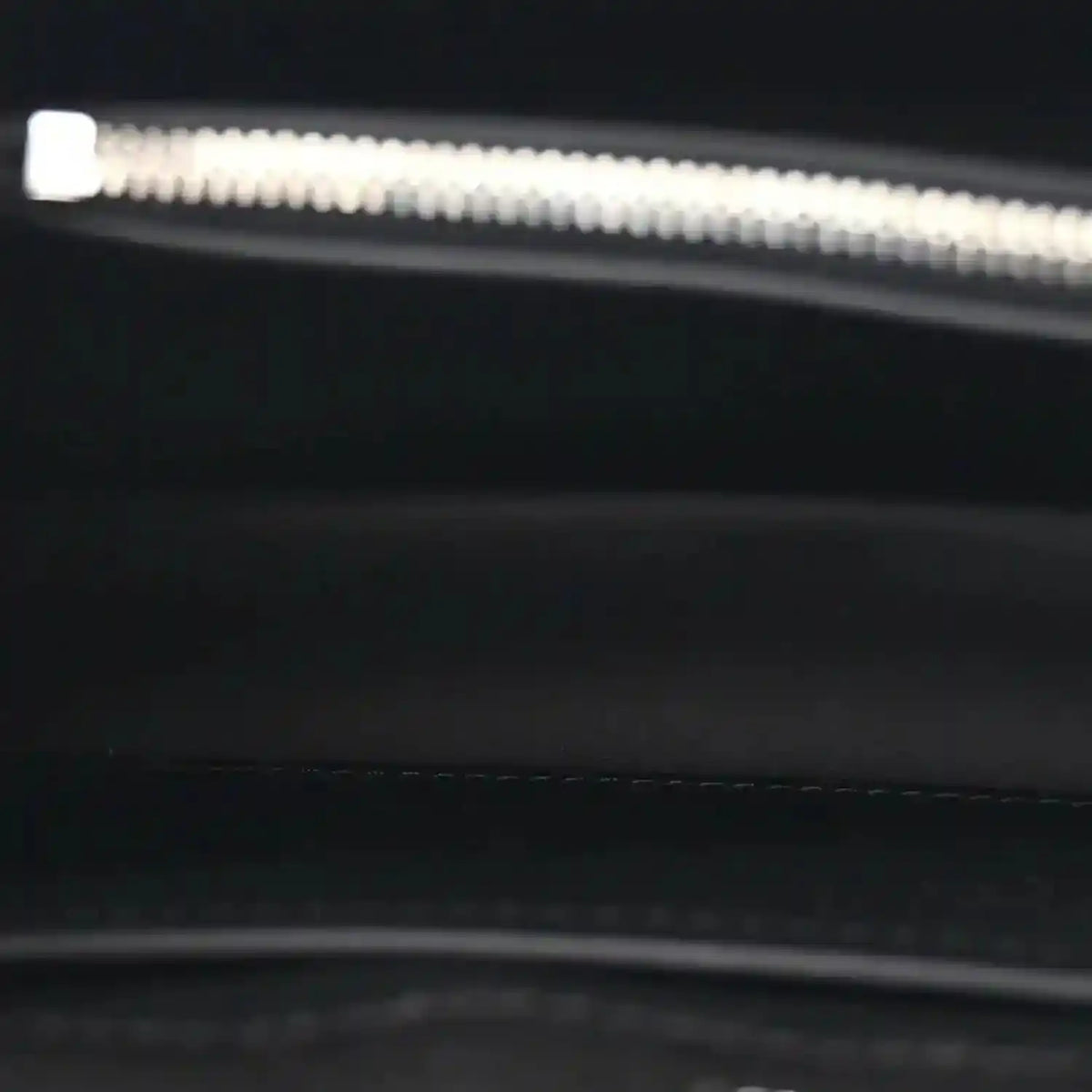 Black leather handbag interior zipper edge with silver hardware
